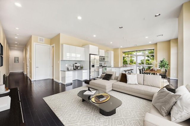 207 Pierce St Unit 205, Houston, TX 77002 - living area featuring recessed lighting, dark wood-style floors, and baseboards