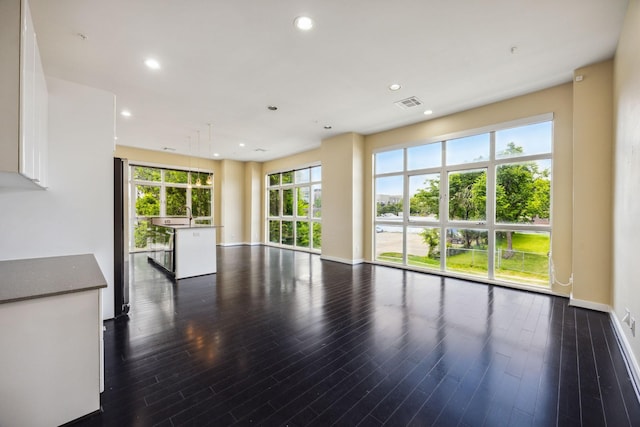 207 Pierce St Unit 205, Houston, TX 77002 - unfurnished living room with dark wood finished floors, recessed lighting, baseboards, and a sink
