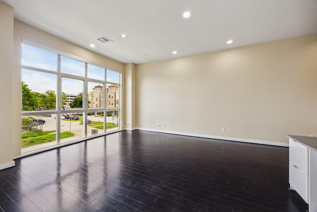 207 Pierce St Unit 205, Houston, TX 77002 - spare room with dark wood-style floors, recessed lighting, and baseboards