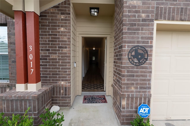 3017 Cambridge Meadows Ln, Dickinson, TX 77539 - view of exterior entry featuring brick siding and a garage