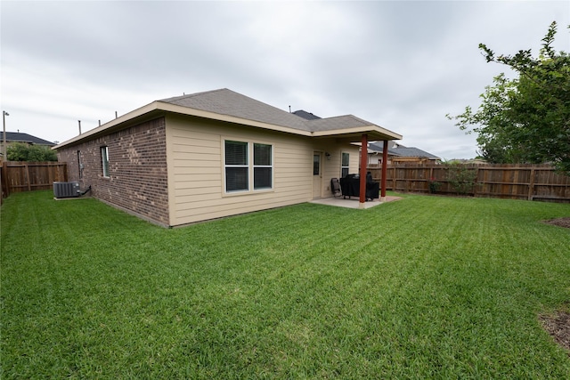 3017 Cambridge Meadows Ln, Dickinson, TX 77539 - back of property with brick siding, a patio area, central air condition unit, and roof with shingles