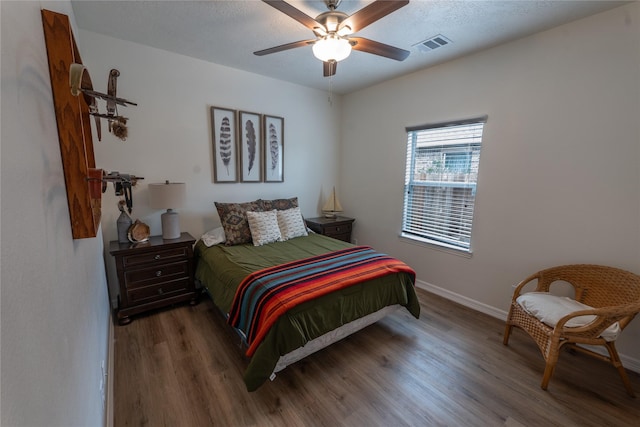 3017 Cambridge Meadows Ln, Dickinson, TX 77539 - bedroom with wood finished floors, baseboards, and a ceiling fan