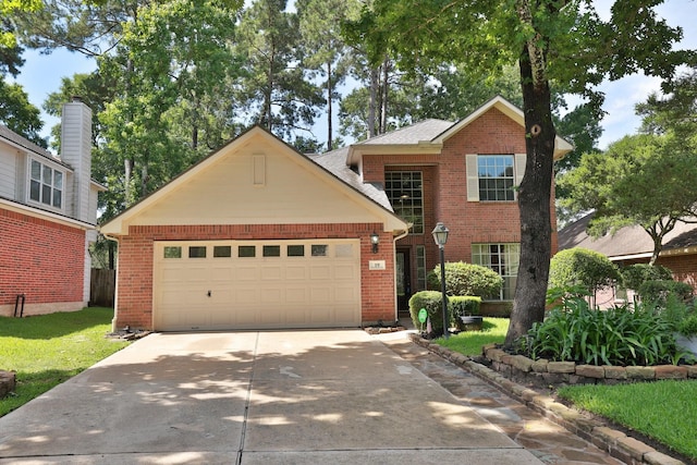 19 Almond Branch Pl, The Woodlands, TX 77382 - traditional home featuring brick siding, concrete driveway, and a garage