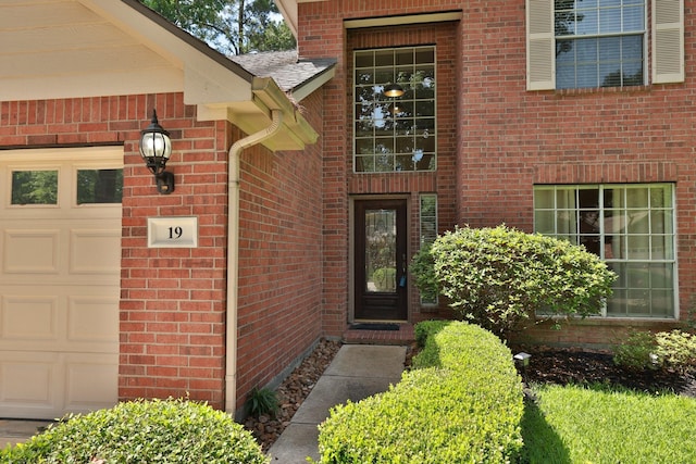 19 Almond Branch Pl, The Woodlands, TX 77382 - view of exterior entry featuring brick siding and a garage
