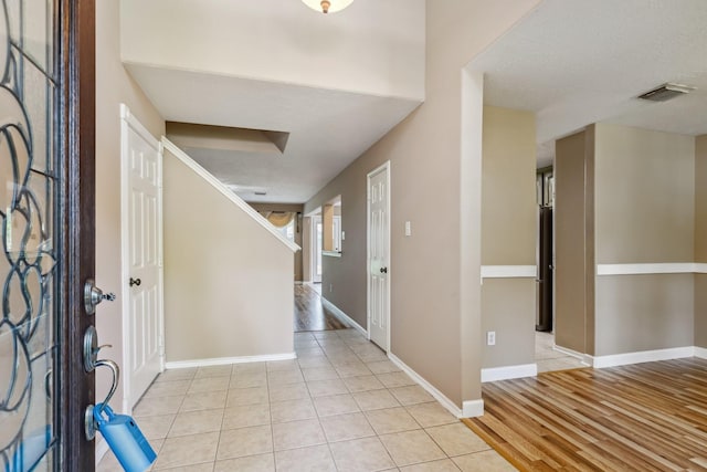 19 Almond Branch Pl, The Woodlands, TX 77382 - entrance foyer featuring light tile patterned floors, baseboards, and stairs