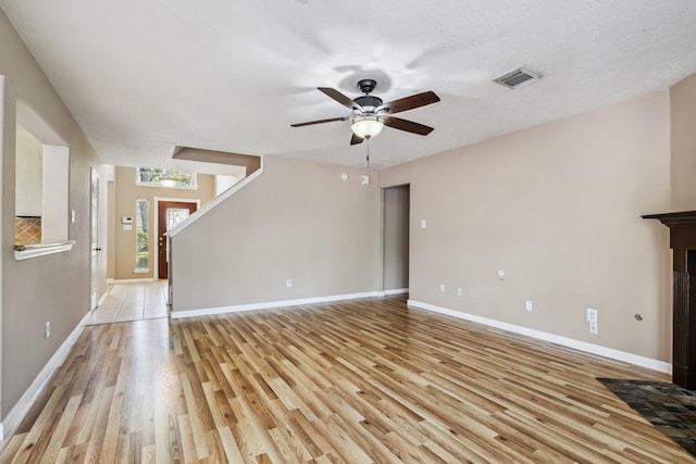 19 Almond Branch Pl, The Woodlands, TX 77382 - unfurnished living room featuring light wood-style floors, ceiling fan, and baseboards