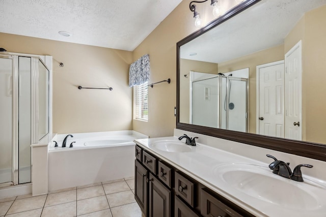 19 Almond Branch Pl, The Woodlands, TX 77382 - bathroom featuring a stall shower, double vanity, a bath, tile patterned flooring, and a textured ceiling