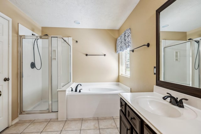 19 Almond Branch Pl, The Woodlands, TX 77382 - full bathroom with a shower stall, vanity, a bath, a textured ceiling, and tile patterned flooring