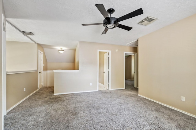 19 Almond Branch Pl, The Woodlands, TX 77382 - empty room with attic access, ceiling fan, carpet flooring, a textured ceiling, and baseboards