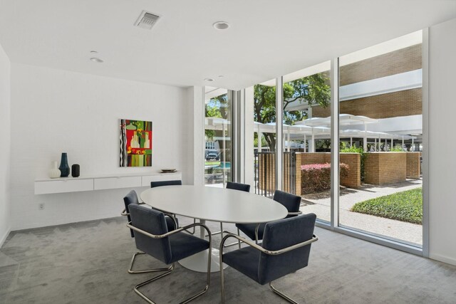 3614 Montrose Blvd Unit 704, Houston, TX 77006 - carpeted dining space with floor to ceiling windows and recessed lighting