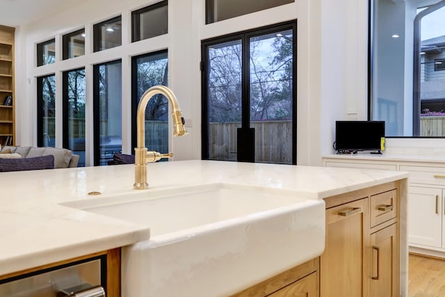 830 Azalea St, Houston, TX 77018 - kitchen featuring a sink, healthy amount of natural light, light wood finished floors, and light stone countertops