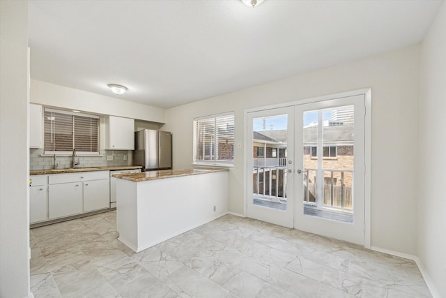 4040 San Felipe St Unit 246, Houston, TX 77027 - kitchen with a sink, freestanding refrigerator, and light marble finish flooring