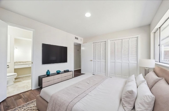 4040 San Felipe St Unit 246, Houston, TX 77027 - bedroom with wood finished floors, two closets, ensuite bathroom, and recessed lighting