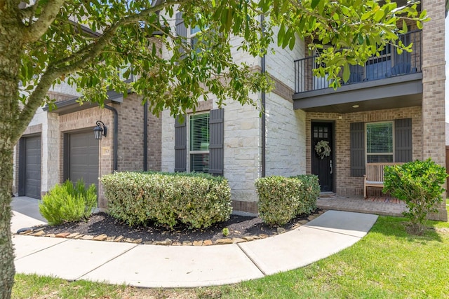 5106 Green Leaf Ln, Fulshear, TX 77441 - entrance to property featuring a balcony, concrete driveway, a garage, brick siding, and covered porch