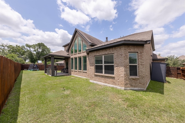 5106 Green Leaf Ln, Fulshear, TX 77441 - rear view of house featuring a gazebo, brick siding, a shingled roof, and a patio area