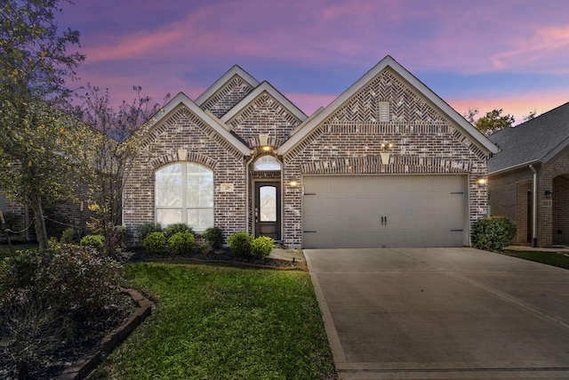229 N Bearkat Ct, Montgomery, TX 77316 - french country home with brick siding, concrete driveway, an attached garage, and a yard