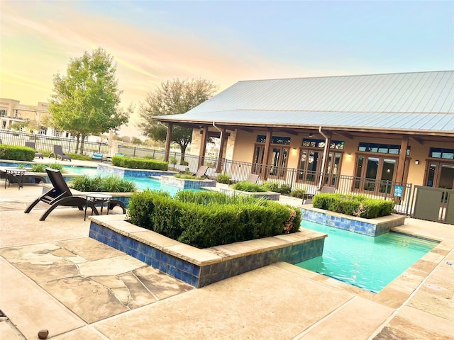 11202 Bluewater Lagoon Cir, Cypress, TX 77433 - pool at dusk with french doors, a patio, and a jacuzzi