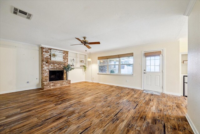 507 Williamsport St, League City, TX 77573 - unfurnished living room with wood finished floors, a ceiling fan, a brick fireplace, baseboards, and ornamental molding