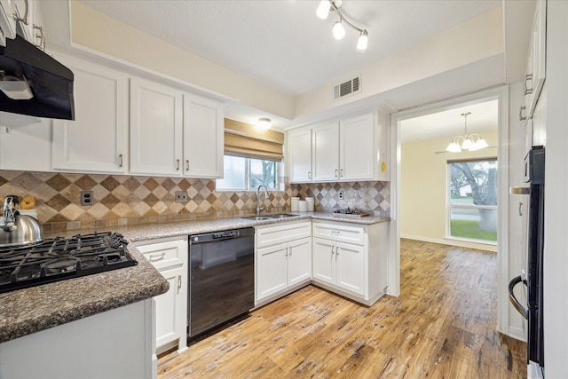 507 Williamsport St, League City, TX 77573 - kitchen featuring black appliances, ventilation hood, a sink, white cabinets, and tasteful backsplash
