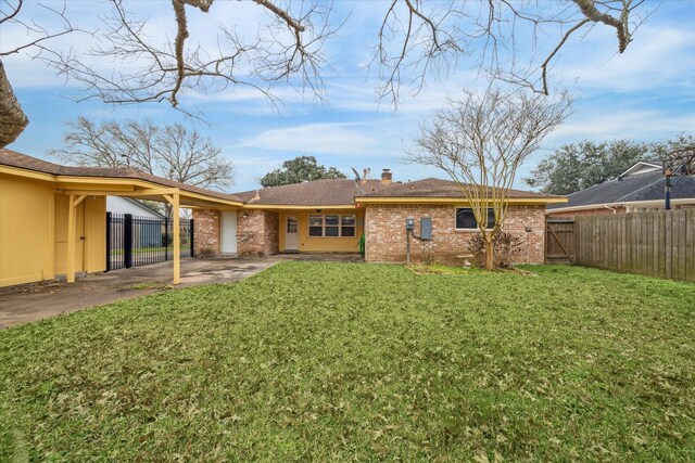 507 Williamsport St, League City, TX 77573 - rear view of house with brick siding, concrete driveway, a chimney, and a gate