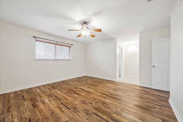 507 Williamsport St, League City, TX 77573 - unfurnished room featuring ceiling fan, wood finished floors, and baseboards