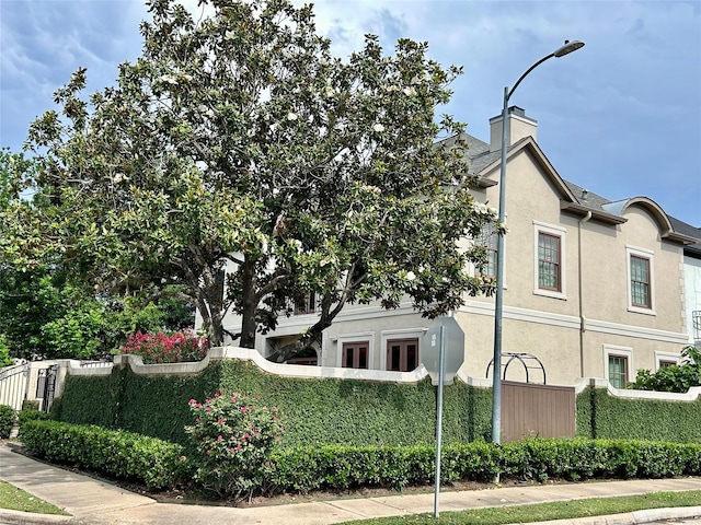 6021 Valley Forge Dr, Houston, TX 77057 - view of side of property featuring stucco siding and a chimney