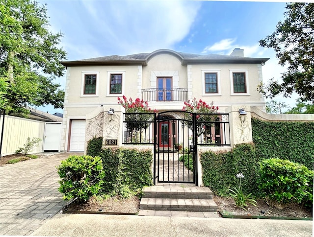 6021 Valley Forge Dr, Houston, TX 77057 - view of front of property with a fenced front yard, stucco siding, a gate, a balcony, and a chimney
