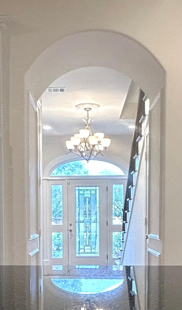 6021 Valley Forge Dr, Houston, TX 77057 - entryway featuring arched walkways, a chandelier, stairway, and plenty of natural light