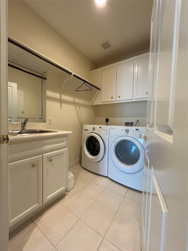 6021 Valley Forge Dr, Houston, TX 77057 - laundry room featuring cabinet space, washing machine and dryer, and light tile patterned flooring