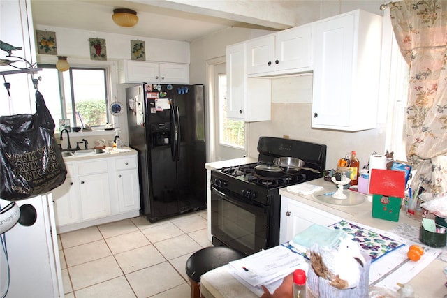 10406 Broadstairs St, Houston, TX 77013 - kitchen featuring black appliances, a sink, light tile patterned flooring, and light countertops