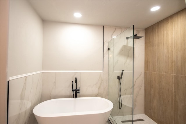 7707 Kempsey Ln, Houston, TX 77040 - bathroom with a marble finish shower, a freestanding bath, tile walls, and recessed lighting