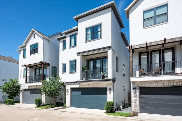 1747 Ojeman Spring Ln, Houston, TX 77055 - view of property featuring a garage, stucco siding, and driveway