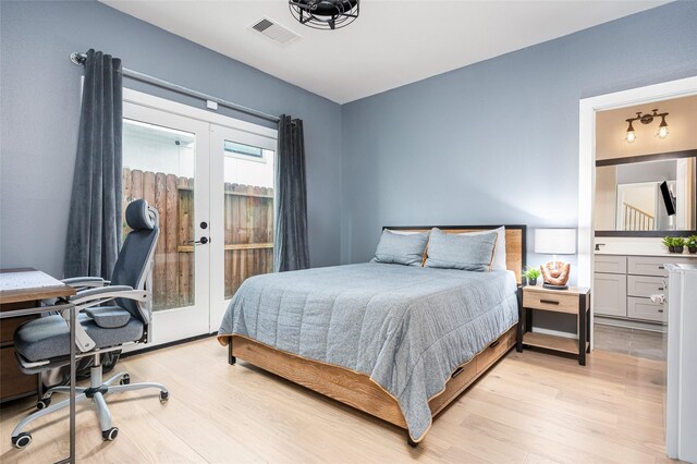 1747 Ojeman Spring Ln, Houston, TX 77055 - bedroom featuring french doors, light wood finished floors, an office area, access to outside, and ensuite bath