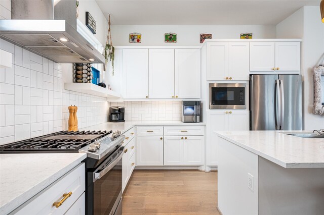 1747 Ojeman Spring Ln, Houston, TX 77055 - kitchen featuring stainless steel appliances, wall chimney exhaust hood, white cabinets, and open shelves