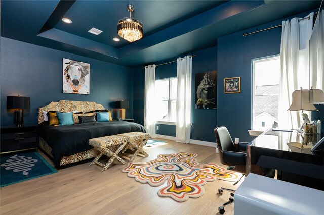 1747 Ojeman Spring Ln, Houston, TX 77055 - bedroom featuring wood finished floors, a raised ceiling, and recessed lighting