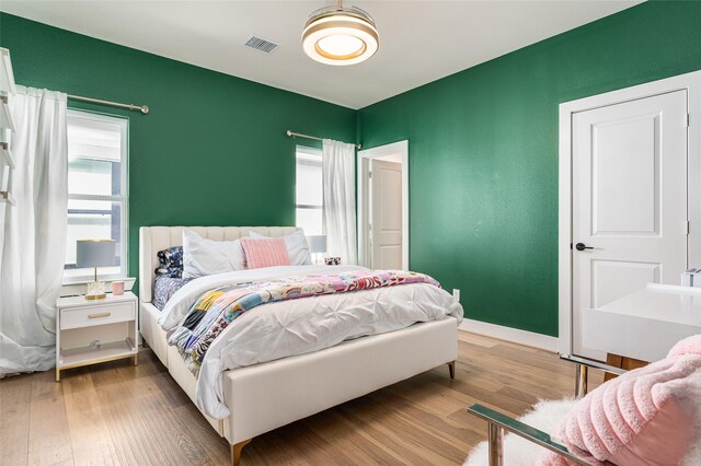 1747 Ojeman Spring Ln, Houston, TX 77055 - bedroom featuring wood finished floors and multiple windows
