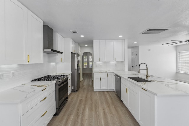 16739 Innisbrook Dr, Houston, TX 77095 - kitchen with stainless steel appliances, wall chimney range hood, a peninsula, arched walkways, and a sink