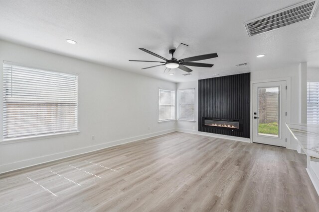 16739 Innisbrook Dr, Houston, TX 77095 - unfurnished living room featuring a ceiling fan, light wood-style floors, baseboards, recessed lighting, and a fireplace