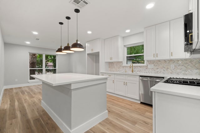 9 Indian Cedar Ln, The Woodlands, TX 77380 - kitchen with stainless steel dishwasher, a sink, decorative backsplash, healthy amount of natural light, and recessed lighting