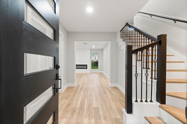 9 Indian Cedar Ln, The Woodlands, TX 77380 - entryway featuring light wood finished floors, stairway, baseboards, and recessed lighting