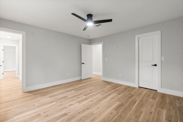 9 Indian Cedar Ln, The Woodlands, TX 77380 - unfurnished bedroom featuring light wood-style floors, baseboards, and ceiling fan