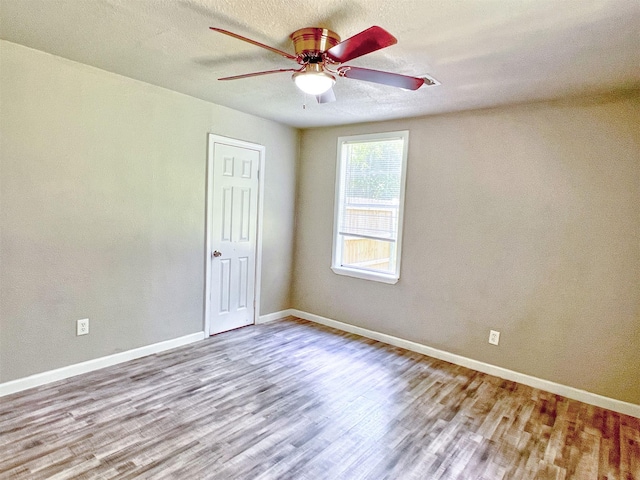 5813 Mayle St, Houston, TX 77016 - unfurnished room with wood finished floors, a ceiling fan, baseboards, and a textured ceiling