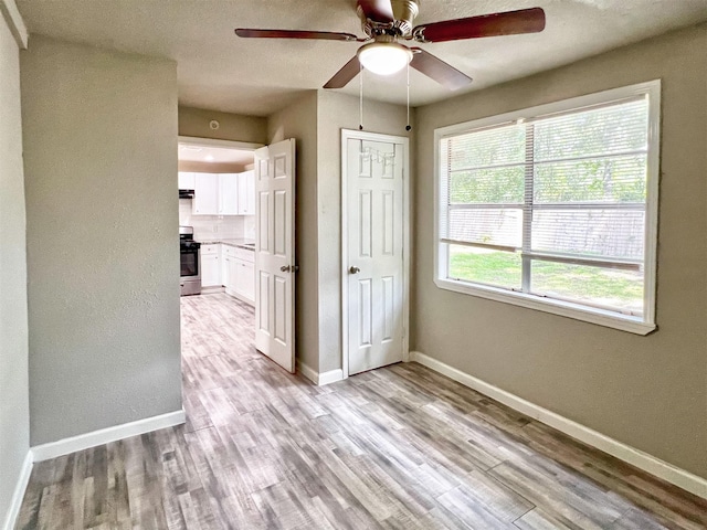 5813 Mayle St, Houston, TX 77016 - unfurnished room with a ceiling fan, light wood-style floors, and baseboards