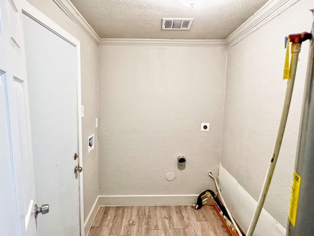 5813 Mayle St, Houston, TX 77016 - laundry room featuring light wood-type flooring, a textured ceiling, hookup for an electric dryer, hookup for a washing machine, and baseboards