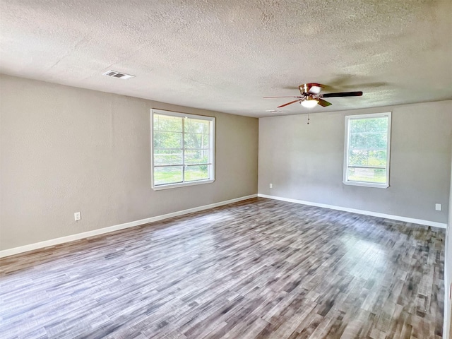 5813 Mayle St, Houston, TX 77016 - spare room with plenty of natural light, a textured ceiling, wood finished floors, and ceiling fan