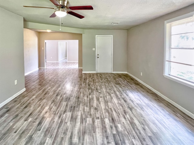 5813 Mayle St, Houston, TX 77016 - unfurnished room featuring ceiling fan, wood finished floors, baseboards, and a textured ceiling
