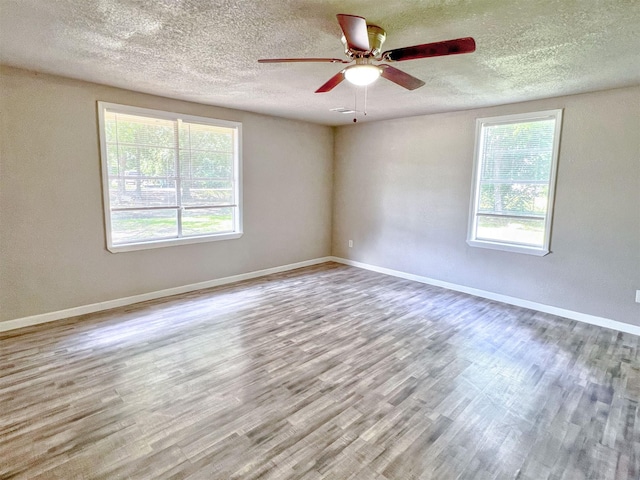 5813 Mayle St, Houston, TX 77016 - spare room featuring healthy amount of natural light, a textured ceiling, wood finished floors, a ceiling fan, and baseboards