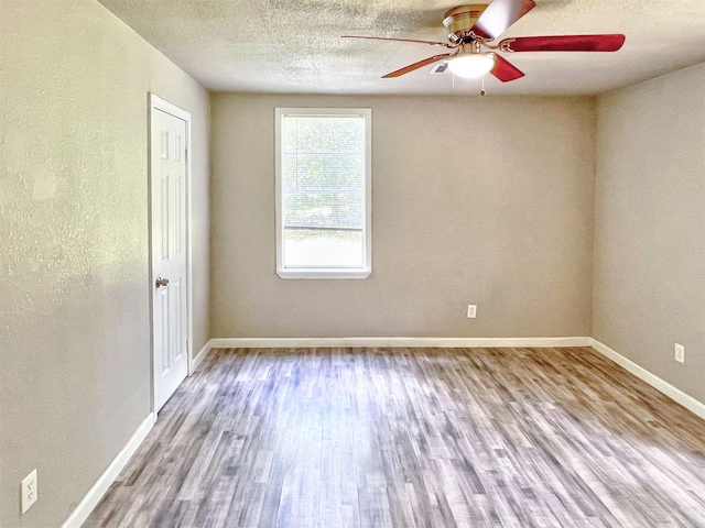 5813 Mayle St, Houston, TX 77016 - unfurnished room featuring wood finished floors, a ceiling fan, baseboards, and a textured ceiling