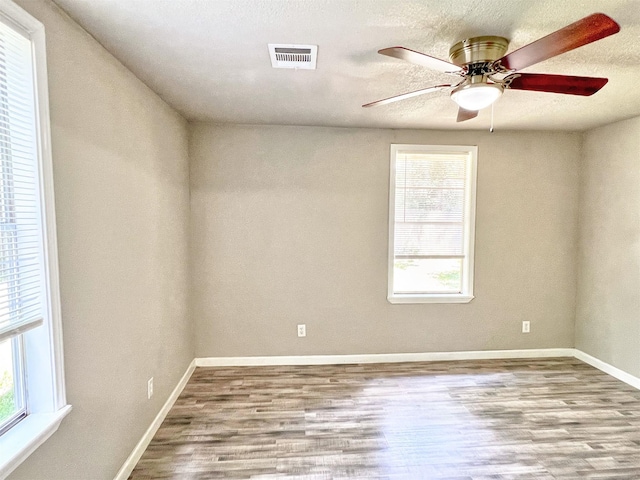 5813 Mayle St, Houston, TX 77016 - spare room with wood finished floors, ceiling fan, and baseboards