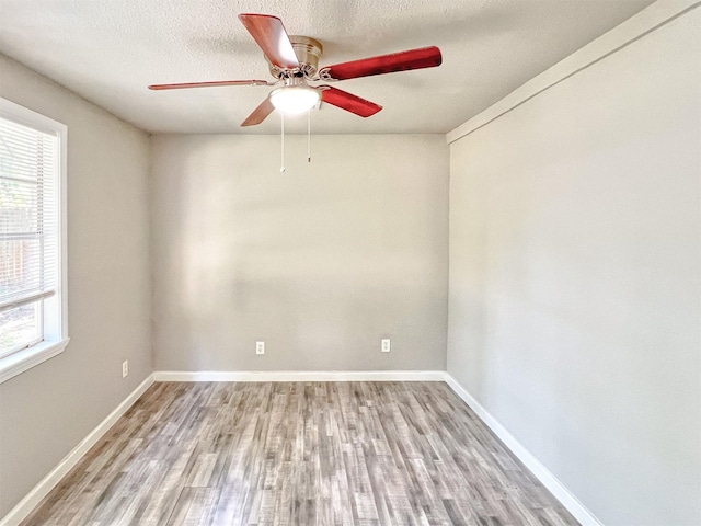 5813 Mayle St, Houston, TX 77016 - unfurnished room with wood finished floors, healthy amount of natural light, a ceiling fan, and baseboards